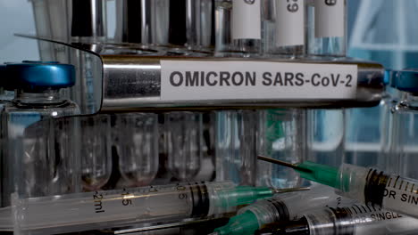 Putting-test-tubes-into-rack-labelled-as-Omicron,-after-specimen-collection