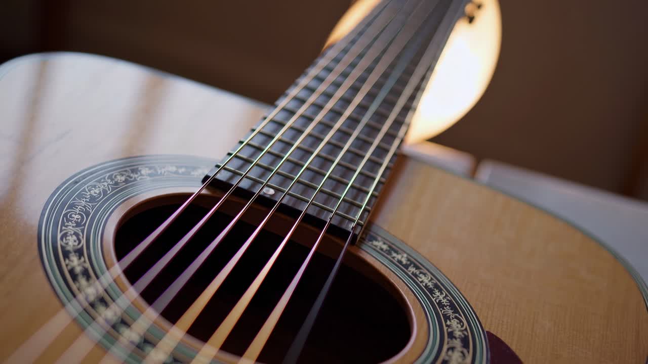 Close-up, low-angle shot of an acoustic guitar's strings and soundhole, capturing intricate details