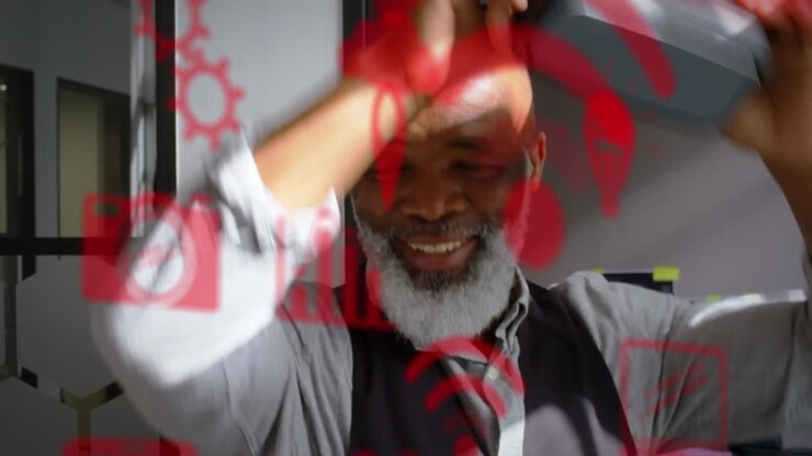 Multiple red digital icons over african american senior businessman wearing a vr headset at office