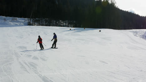 Father-and-son-skiing-on-snowy-alps