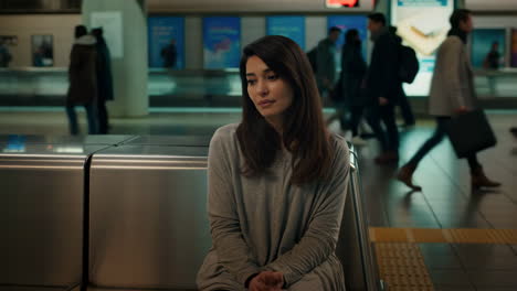 woman waiting at a subway station