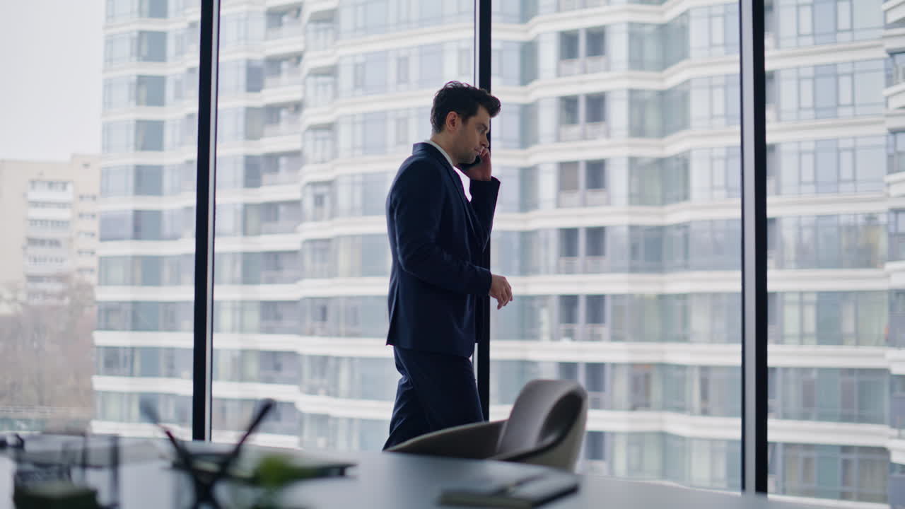 Lawyer discussing deal smartphone conversation standing by office window