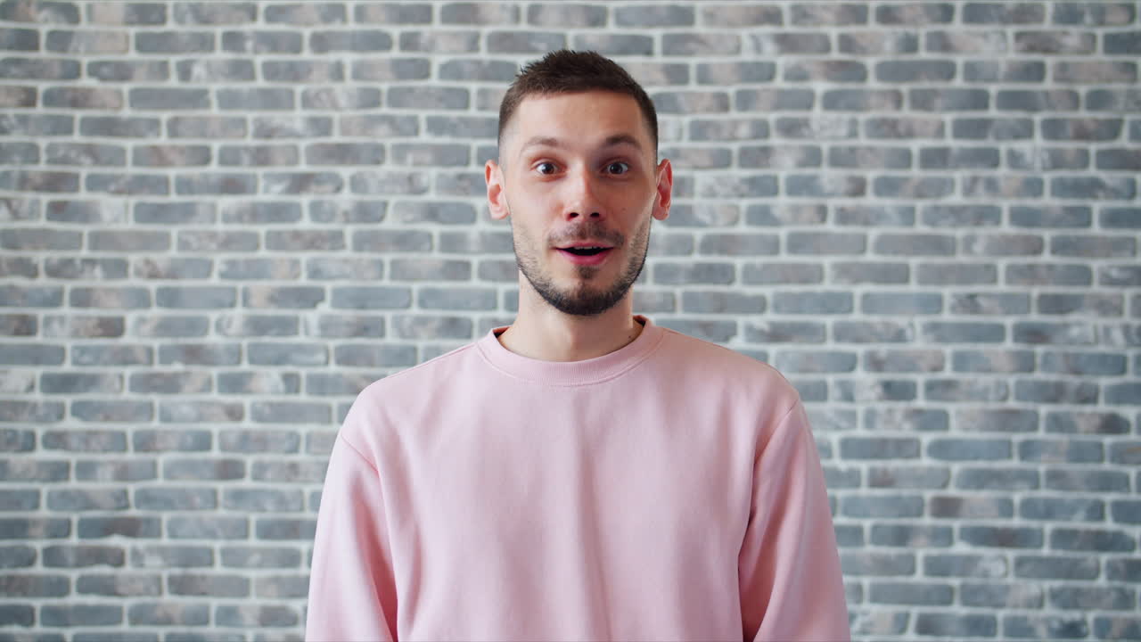 Surprised Man in Pink Sweatshirt