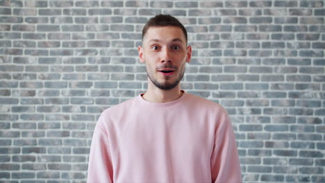 surprised man in pink sweatshirt