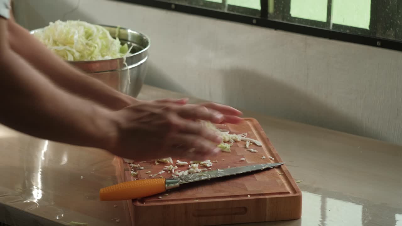 Man Slicing Green Cabbage In The Kitchen. - closeup shot