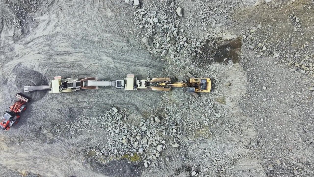 Granite quarry site showing machinery and equipment working on stone extraction at a construction area during a sunny day