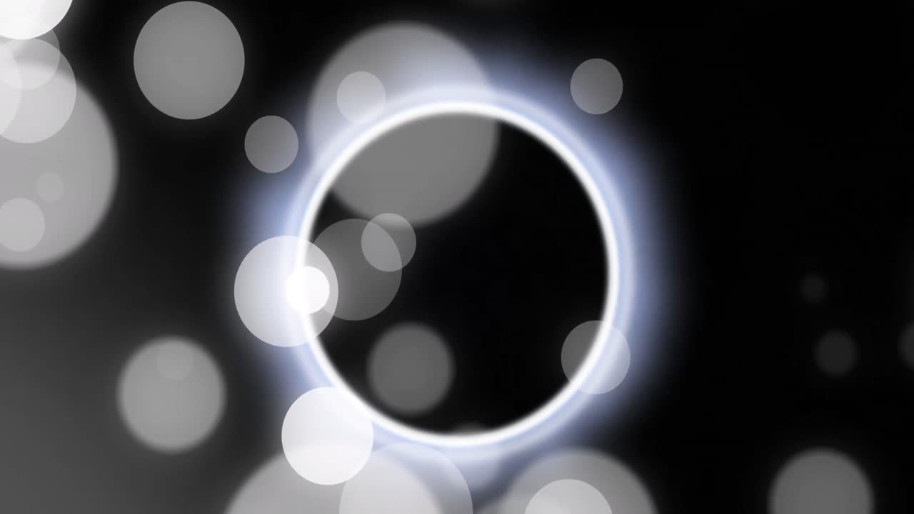 검은 바탕에 움직이는 불빛과 색 모양의 애니메이션.