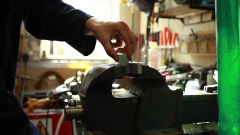 young mechanic working a lathe