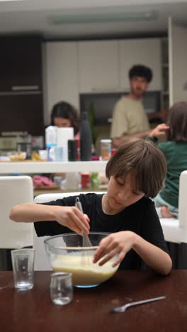 boy baking in the kitchen with his family