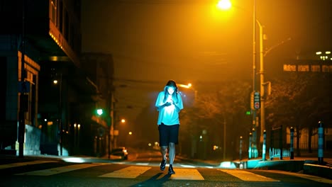 person walking at night in city street