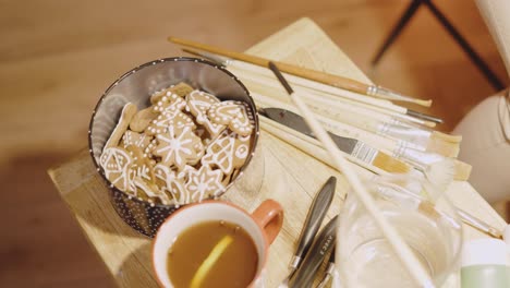 painter picking up gingerbread instead of brush