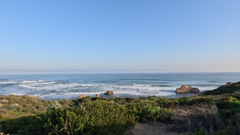 waves crashing against rocks at sunset