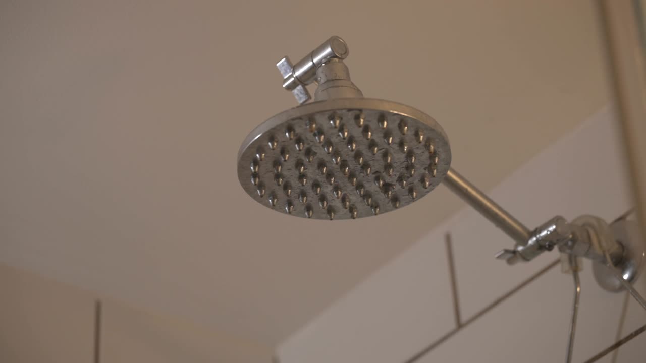 Water Flowing And Dripping From The Rain Shower Head In The Bathroom. - static shot