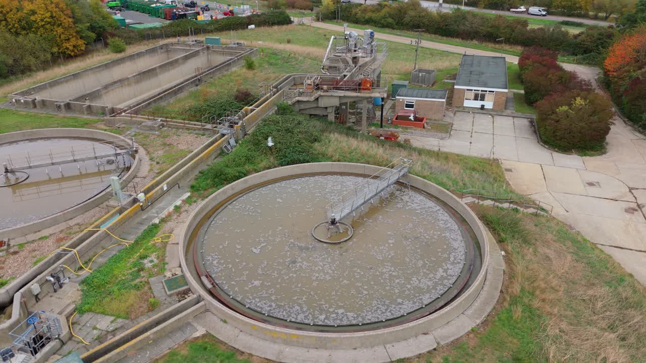 Cinematic drone orbit of a wastewater plant showing removal of solids, chemical treatment processes, and clean drinking water infrastructure