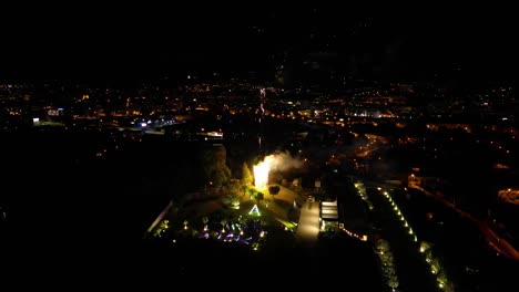 Drone-shot-of-fireworks-over-city-at-night