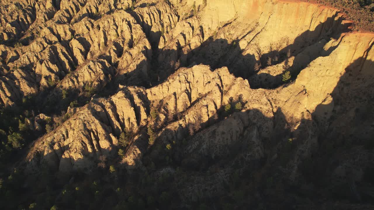 Desert mountains. Badlands. Aerial view. Low-altitude flight. Eroded mountains with strange shapes. Gullies, ravines, and gorges. Viewpoint of the End of the World. Purullena, Granada, Spain