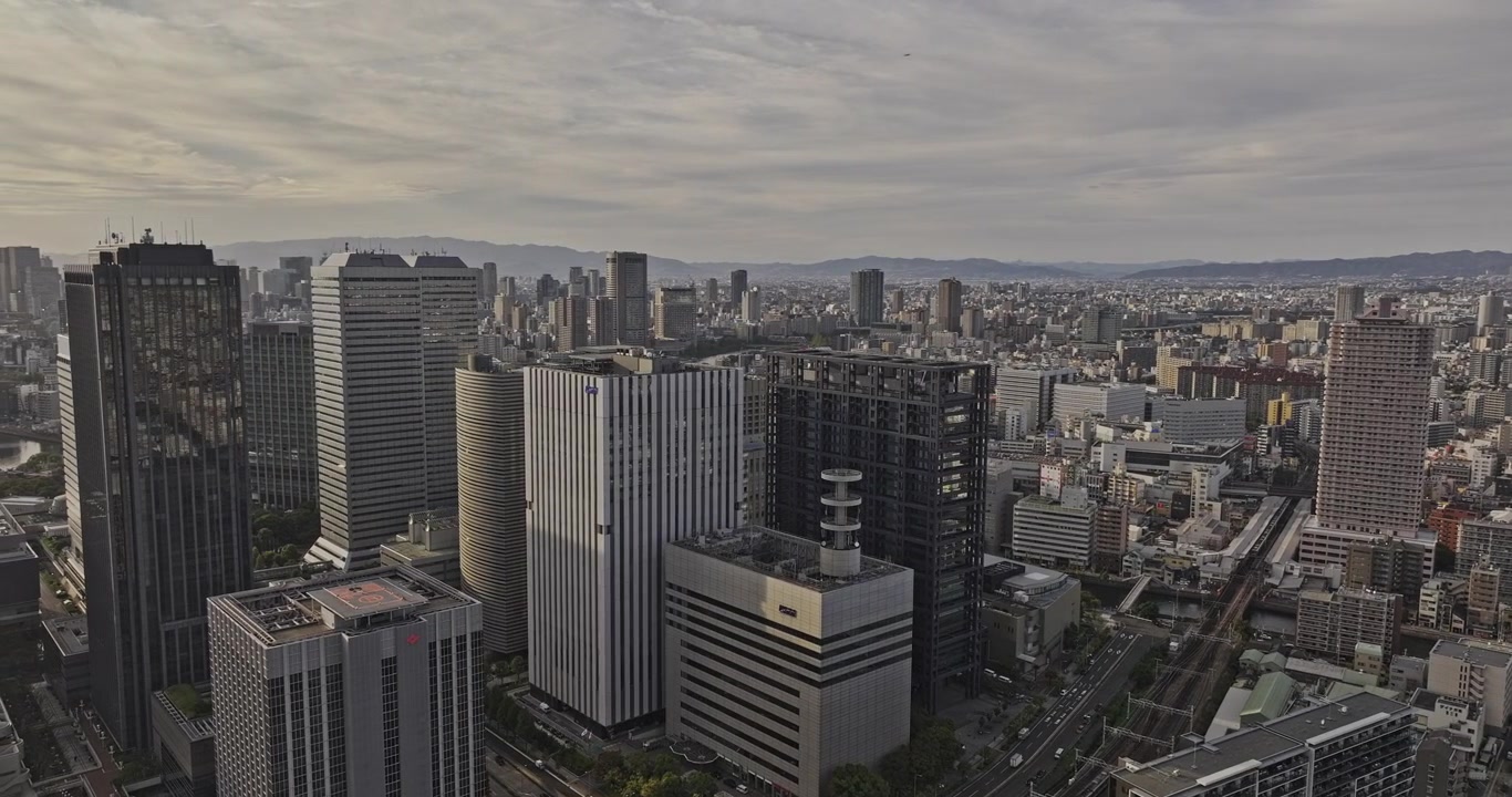 Voo aéreo v70 sobre Osaka, Japão, acima de Shiginonishi e Shiromi, revelando o Osaka Business Park e o horizonte dos distritos de Chuo e Kita ao pôr do sol - Filmado com Mavic 3 Pro Cine - 9 de outubro de 2023