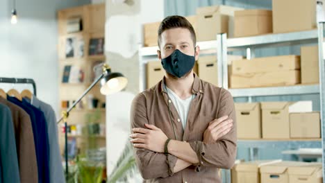 African-American-designer-man-in-black-mask-looking-at-camera-in-positive-mood-in-clothing-store