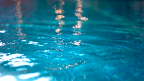 close up shot of flowing water in an outdoor pool in the morning