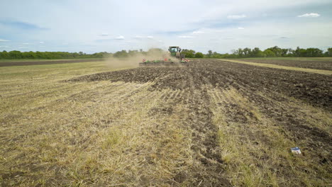 agricultural tractor plowing field. agricultural equipment. plowed field