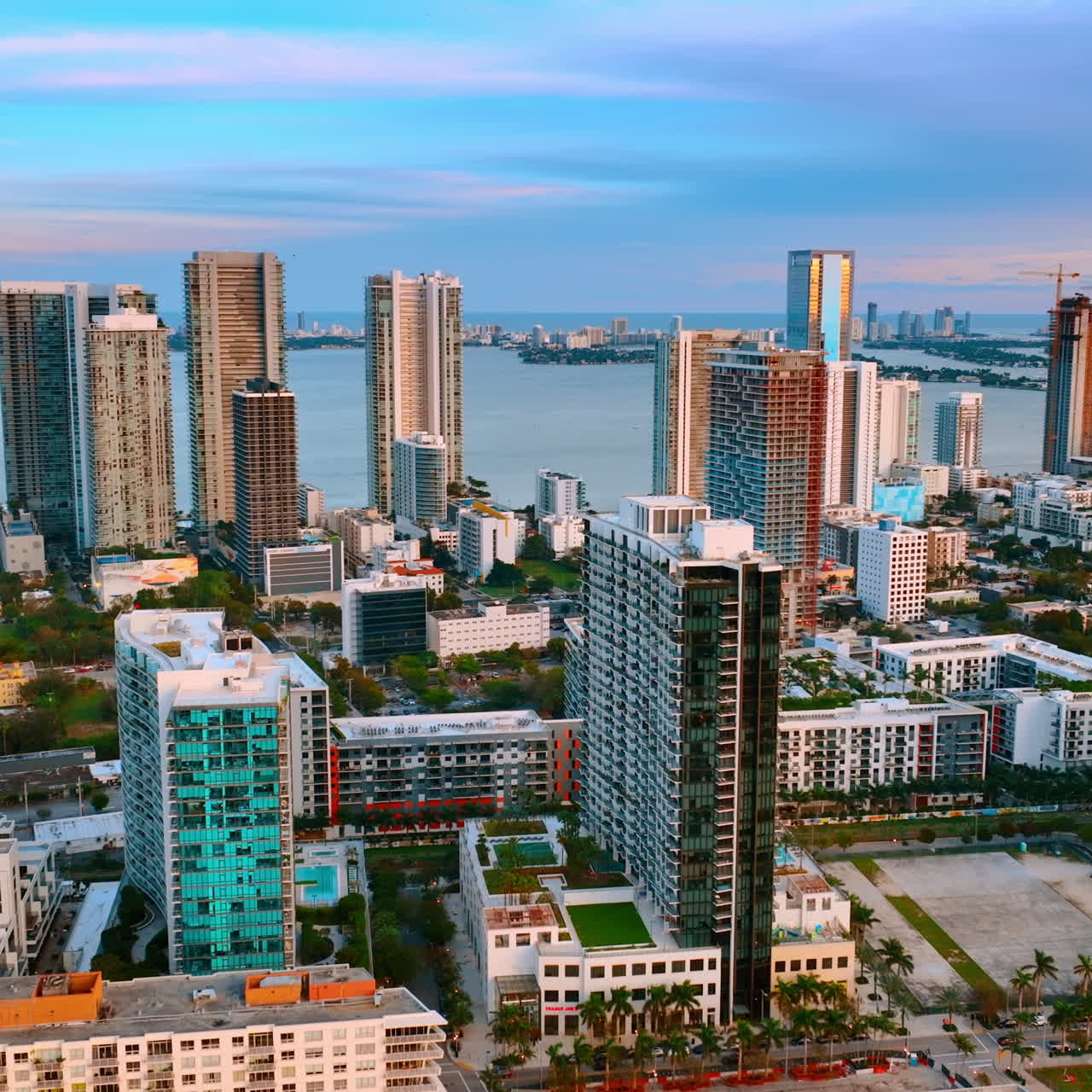 Beautiful high-rise and low-rise buildings in Miami Beach, Florida, USA. Top view. Blue waterscape of the Atlantic Ocean at backdrop.