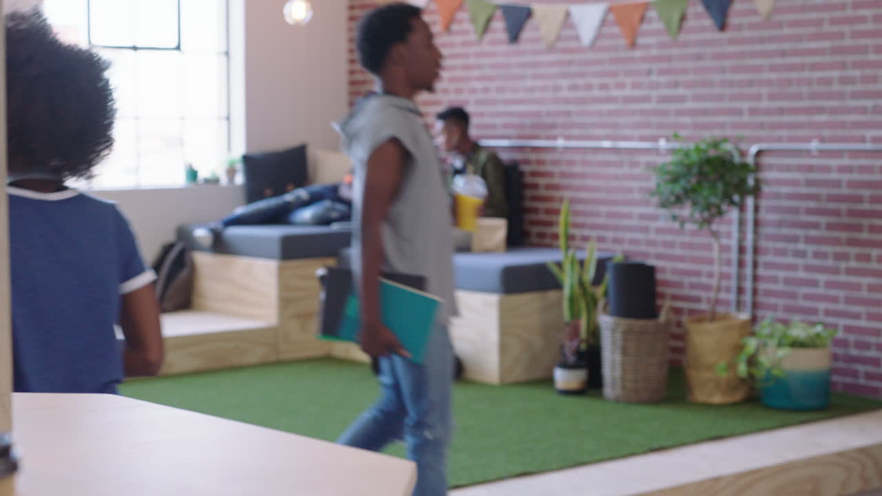 young black business woman checking smartwatch meeting colleagues sharing ideas on creative project in trendy office workplace