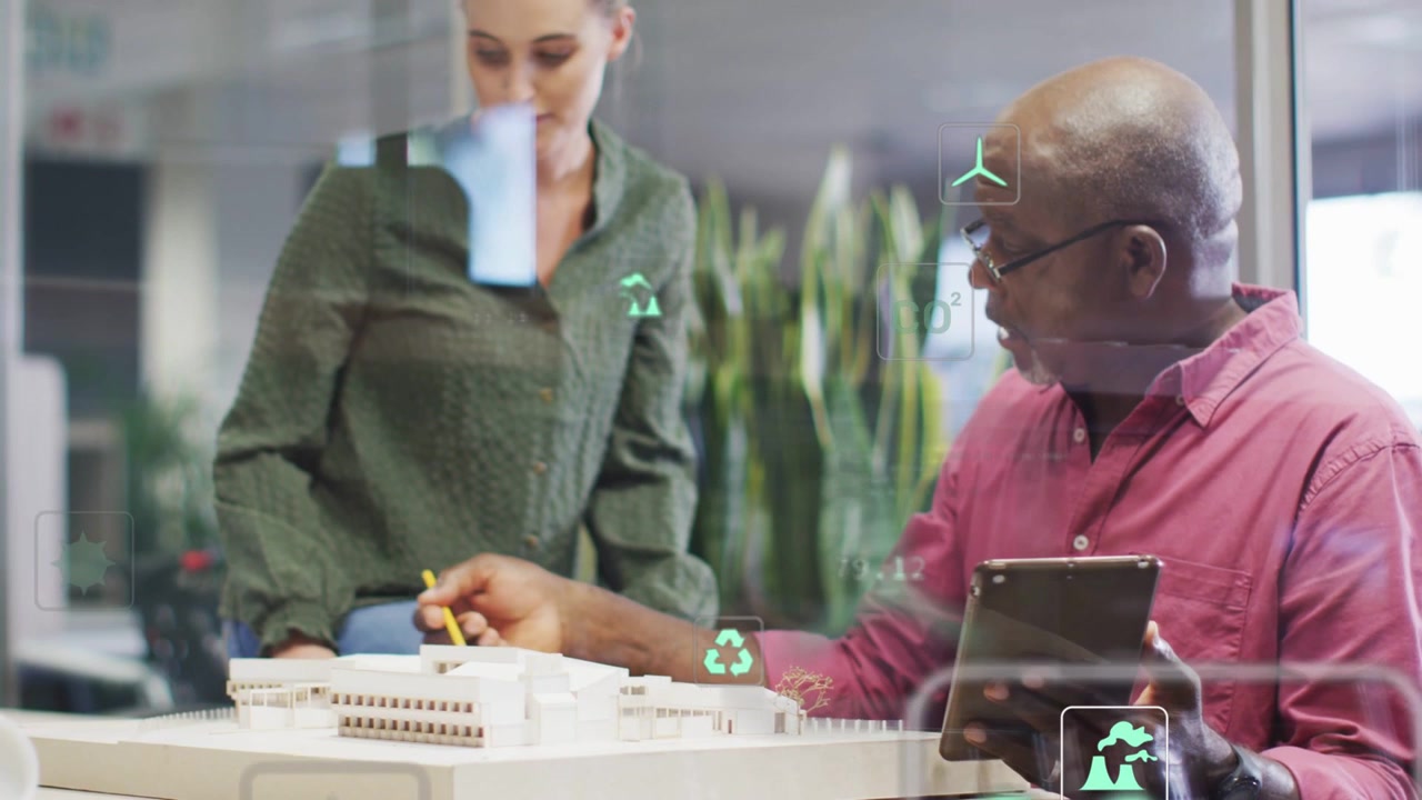 Vertical video: Man tapping tablet pointing pencil woman leaning checking AR model data for plans