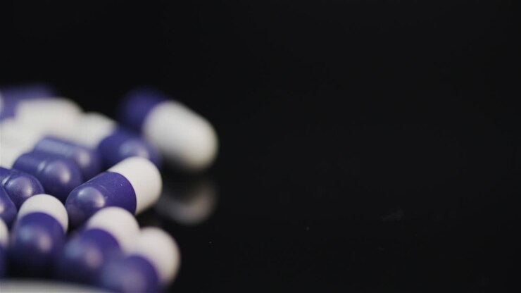 Medicine Pharmacy Concept Extreme Close Up Of Pills With Antibiotic Rotating On Black Background 