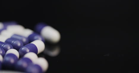 Medicine-Pharmacy-Concept-Extreme-Close-Up-Of-Pills-With-Antibiotic-Rotating-On-Black-Background-