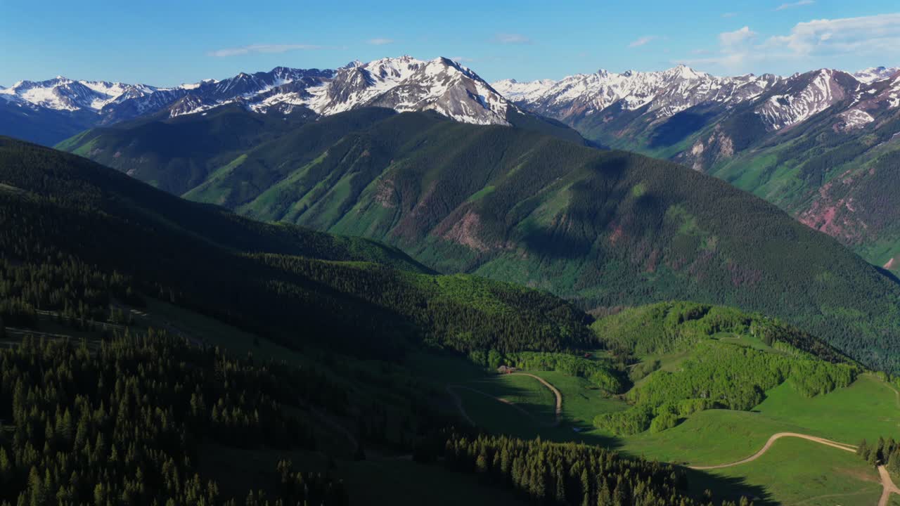Aspen Mountain Ajax Little Annie Trailhead aerial drone Colorado Conundrum creek trail Castle Peak 14er Rocky Mountains Elk Range Aspen Trees spring summer morning blue sky clouds backwards pan up