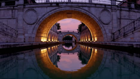 ancient bridge over canal at sunset