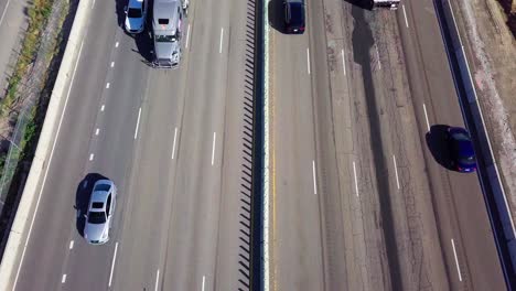 tight aerial orbit around crane, excavator, and dump trucks at a construction site in lehi, utah building interstate 15 i15 at the point of the mountain lehi corridor traffic highway freeway 2017