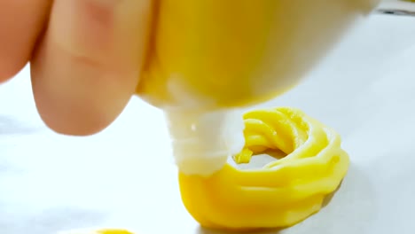 woman prepares delicious cream desserts called zeppole of st. joseph in a baking pan with a saccapoche, italian traditional religious event,  party of daddy, holiday is coming