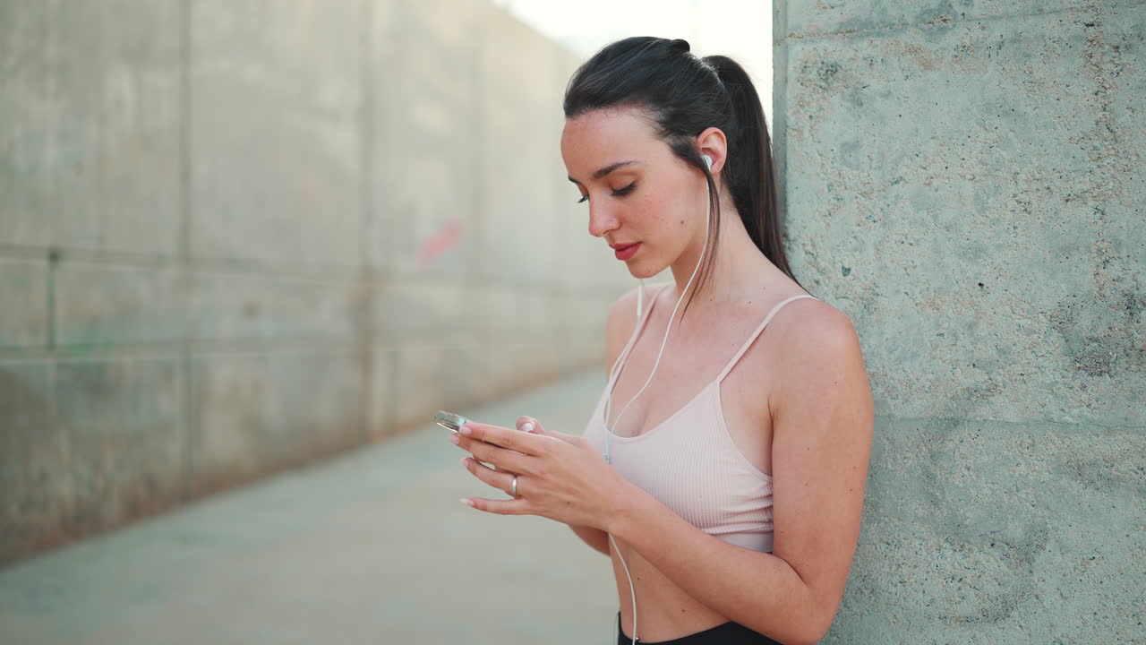 Woman using phone with earphones