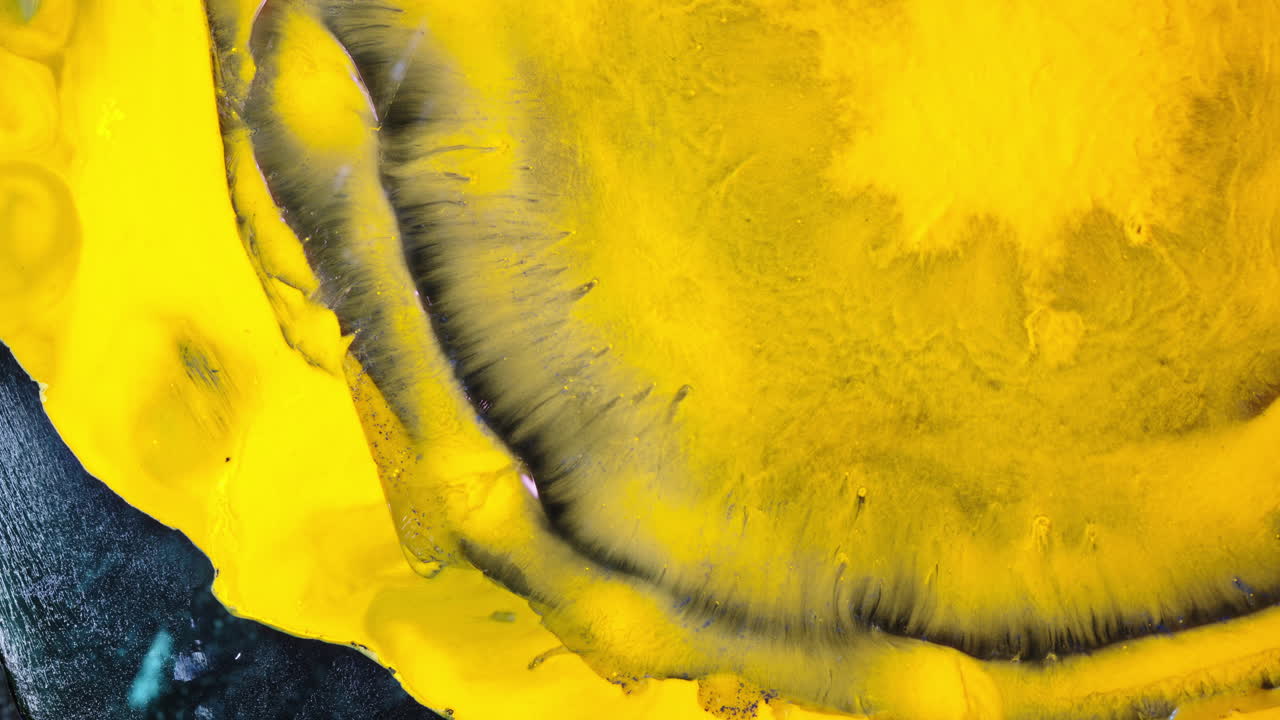 Primo piano di inchiostro giallo vibrante che turbina e si mescola in una vista macro.