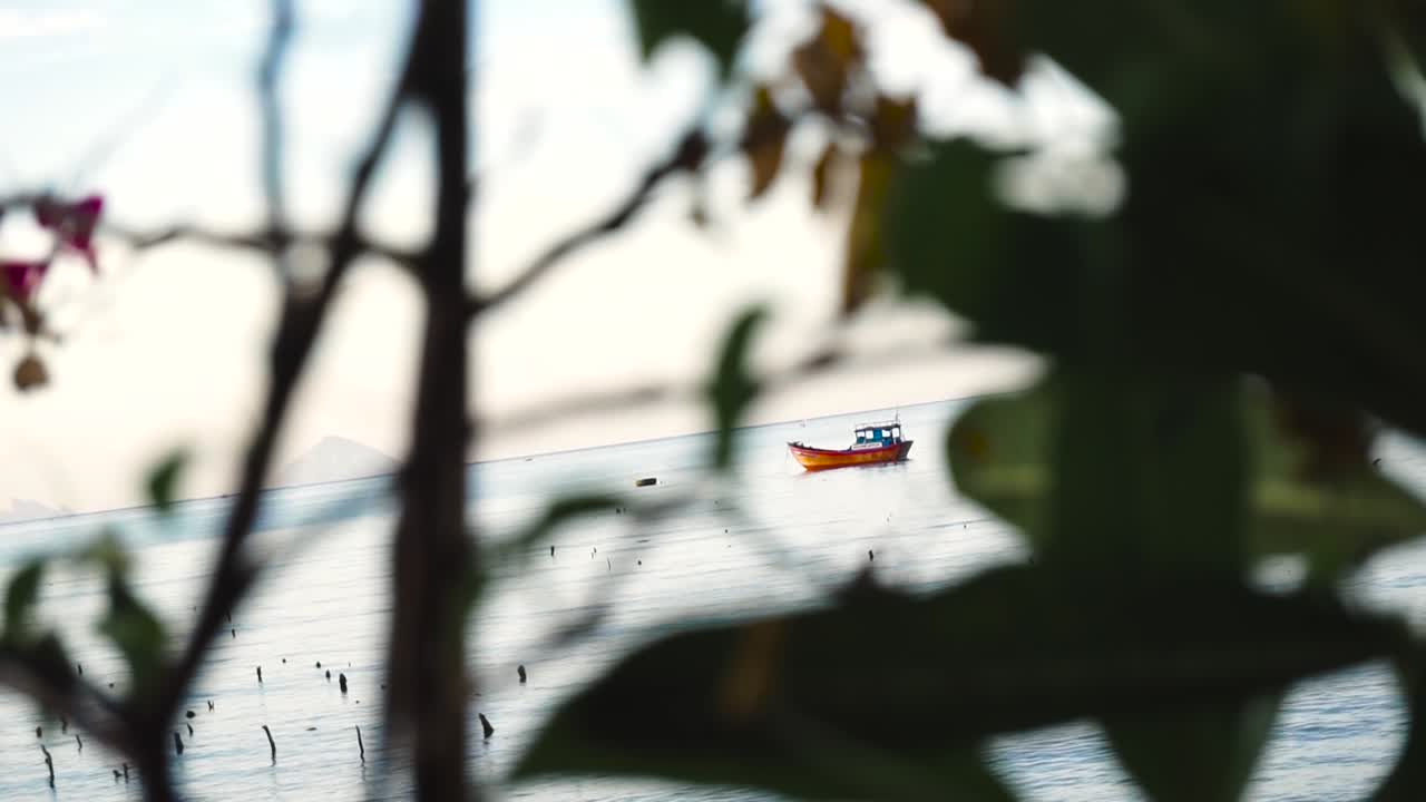 Peaceful view of a fishboat in the sunrise with interesting and unique framing