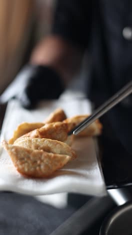 chef preparing fried dumplings