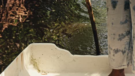 close-up: pole propelling boat on water