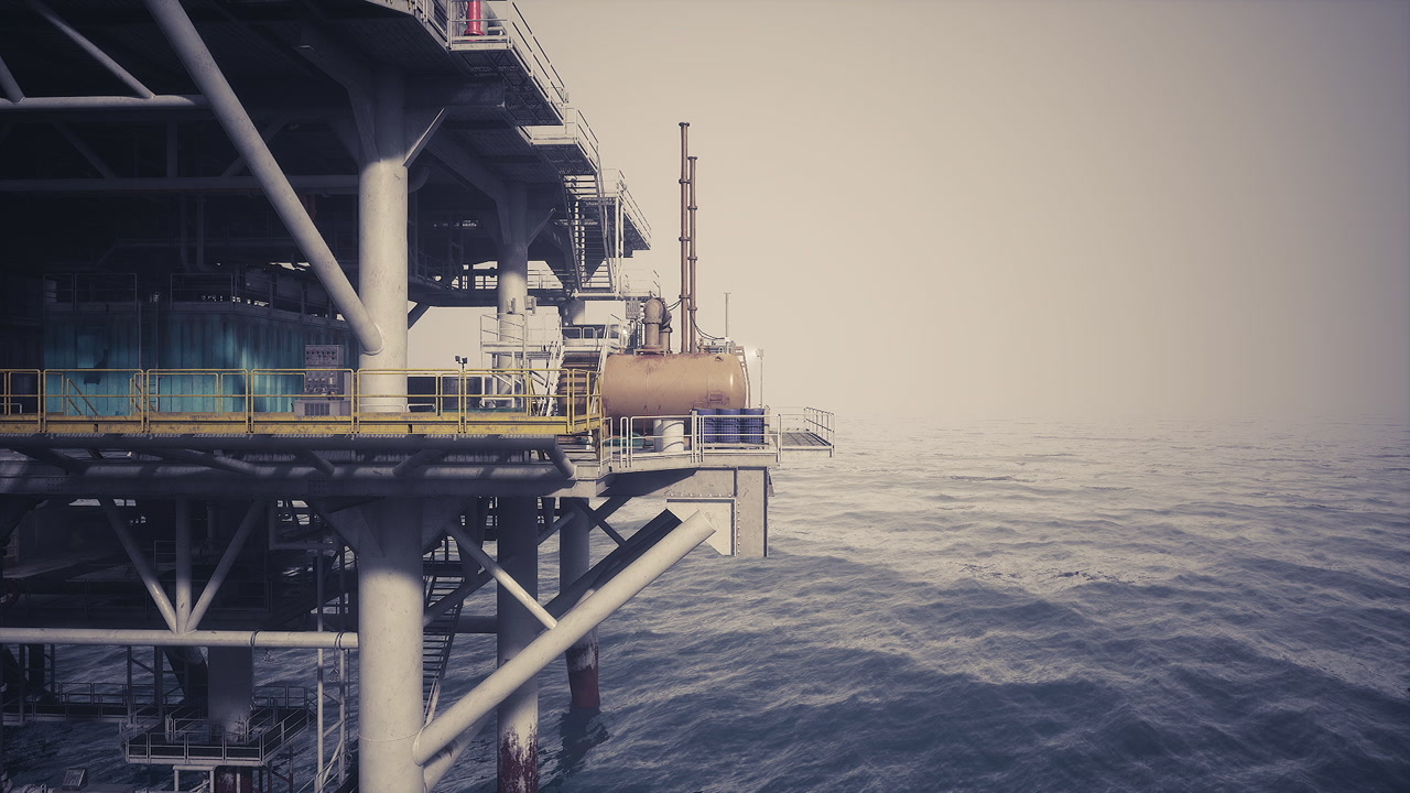 Oil rig platform standing tall over calm ocean waters during daylight hours
