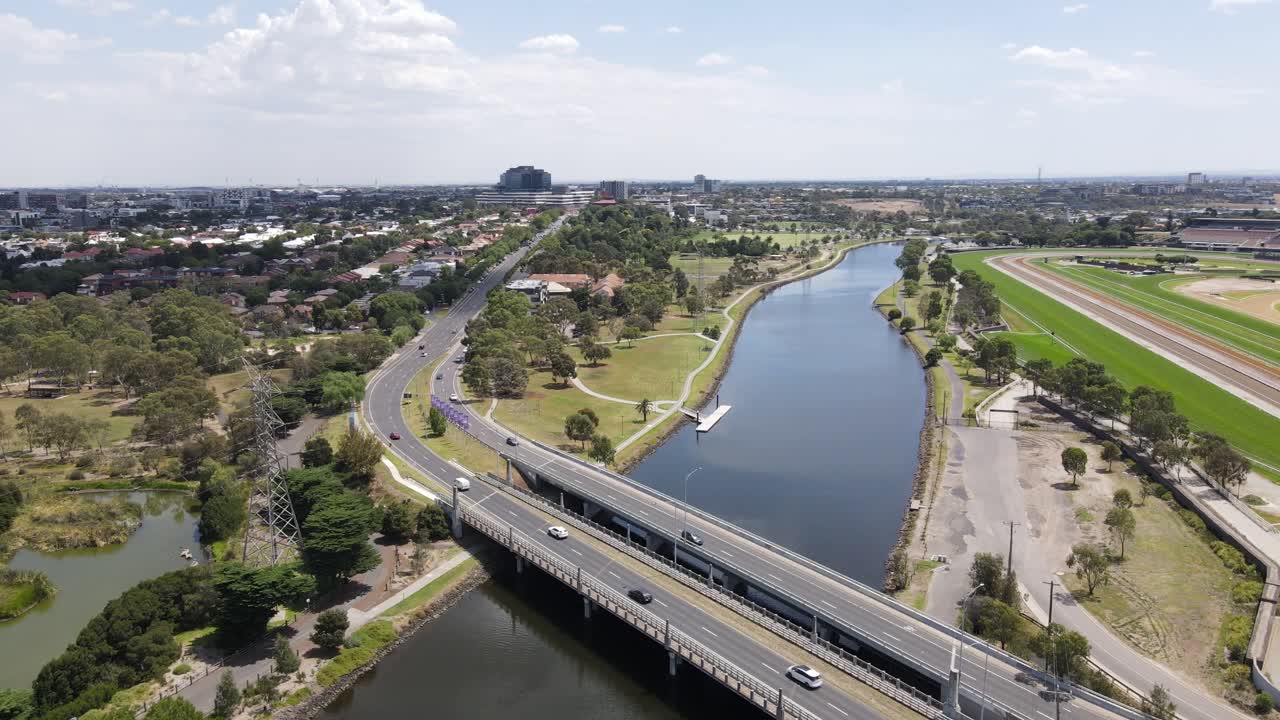 Aerial drone flies over two bridges crossing the Maribyrnong River in Footscray