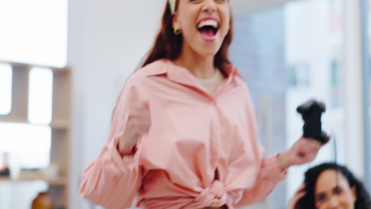 Excited women on sofa, winning at video games