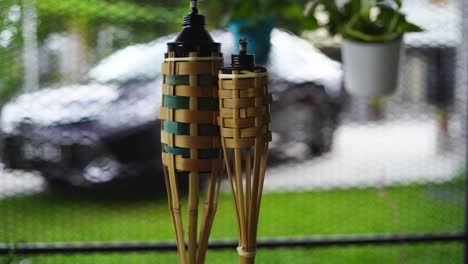 bamboo torch at front yard luxury car as background