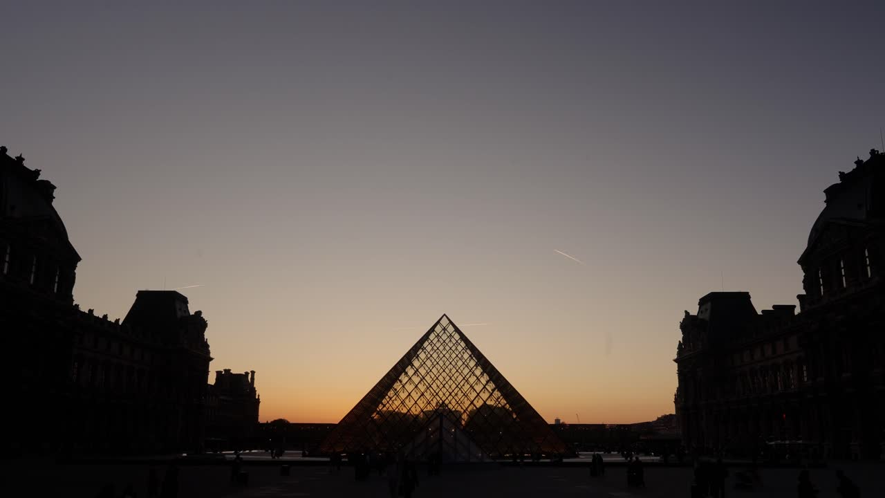 Stunning time lapse view of the Louvre Museum in Paris during sunset in spring.