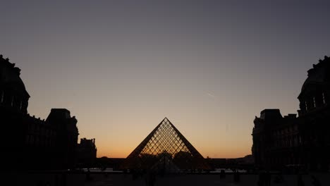 stunning time lapse view of the louvre museum in paris during sunset in spring.