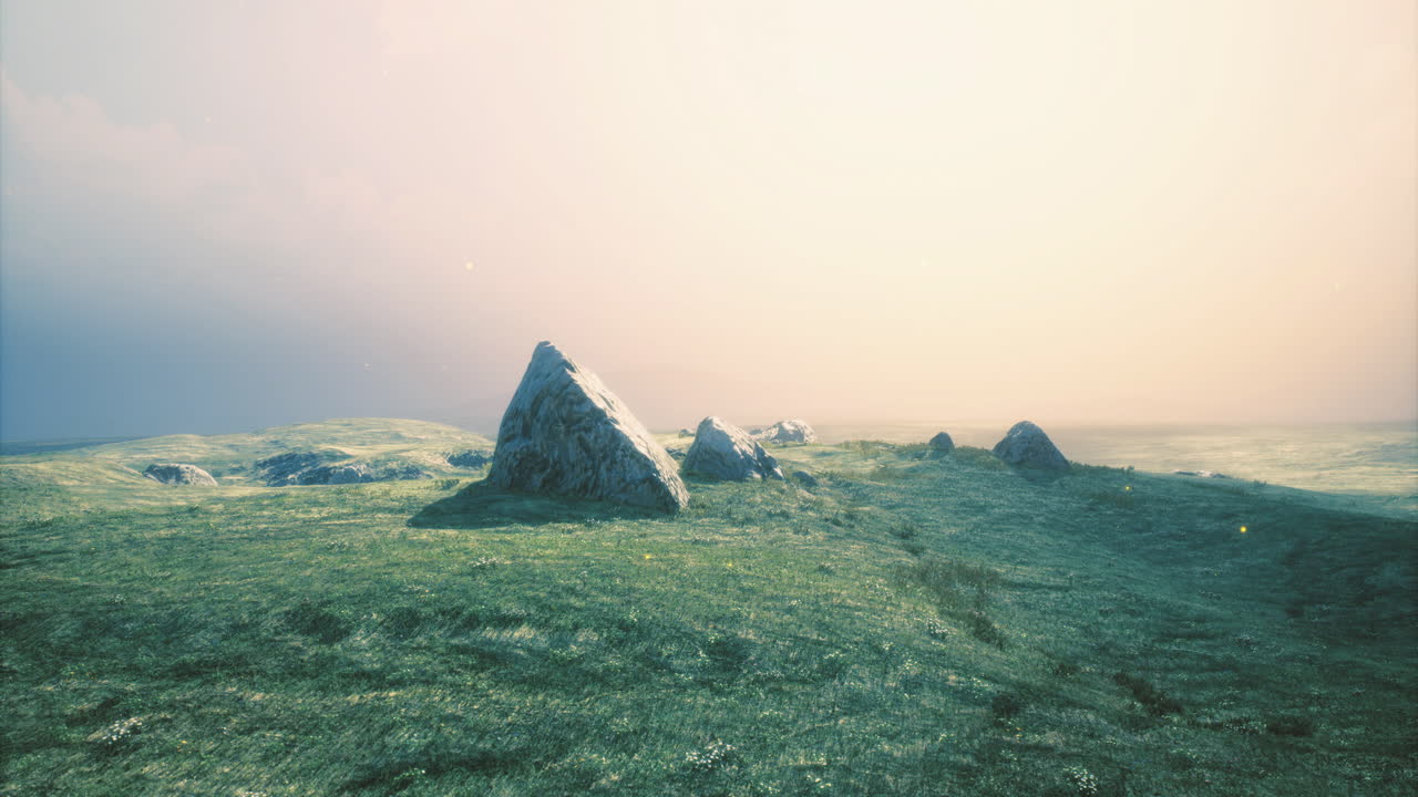 Vast green landscape with unique rock formations under dramatic sky