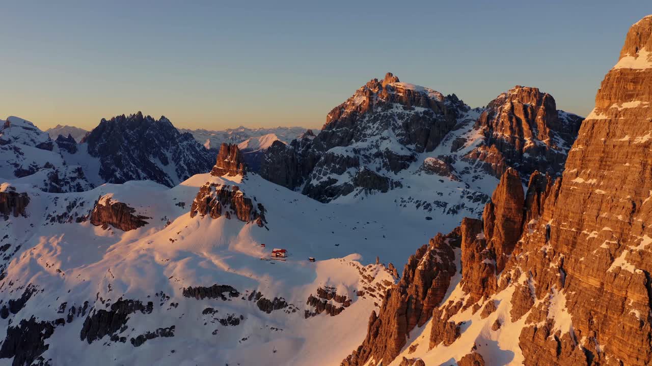 Aerial forward tilt-down view of beautiful Italian Dolomite snowcapped Unesco mountains