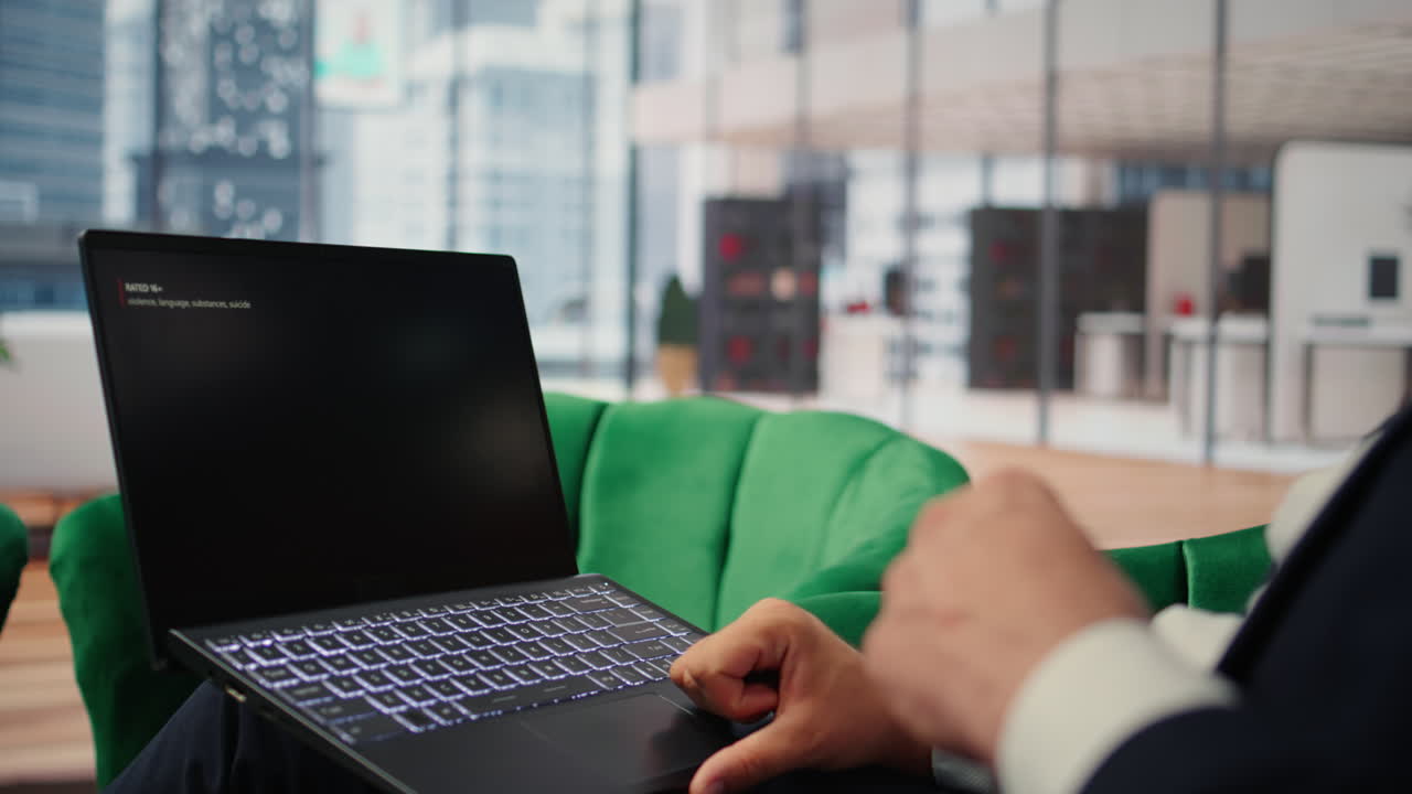 Vertical Video Bucharest, Romania - July 30th 2024 - Young CEO using Netflix to relax in office