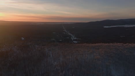 Dense-Forest-In-The-Mountain-With-Sunset-Hue-In-The-Sky-During-Winter-In-Southern-Quebec,-Canada