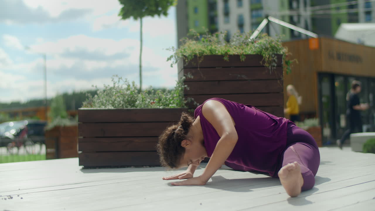 Woman doing Yoga Splits outdoors