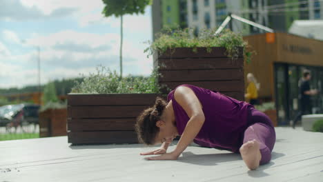 woman doing yoga splits outdoors